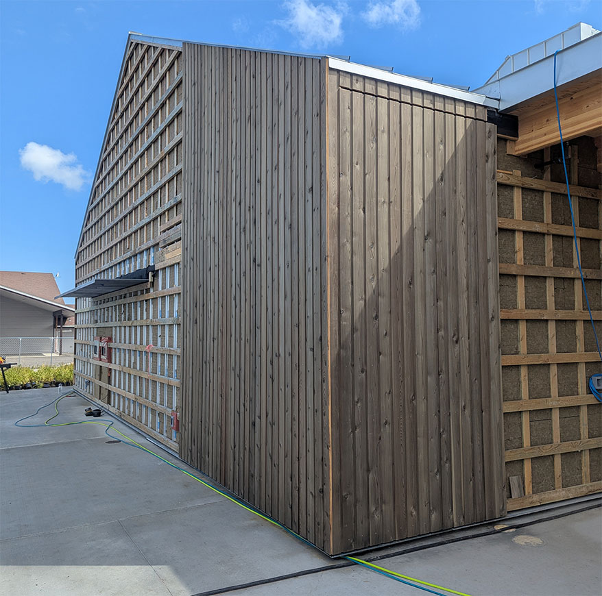Cedar siding has begun to be installed around the building’s exterior.