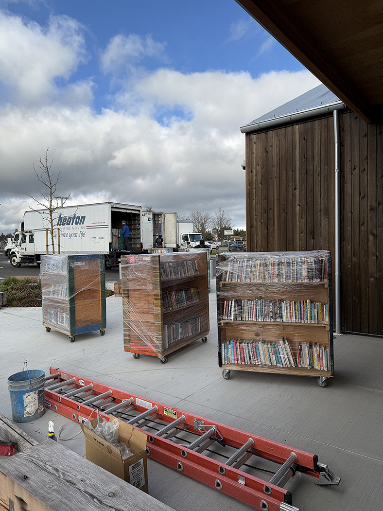 One by one, carts are moved in quick stages while construction continues on site.