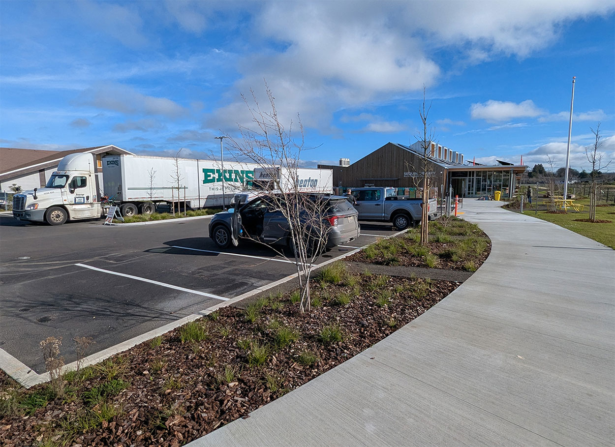 Moving trucks carried several loads of materials to the new building.