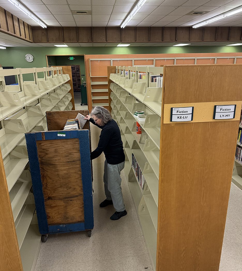 Staff loaded nearly 50,000 items onto moving carts with color-coded labels by section.